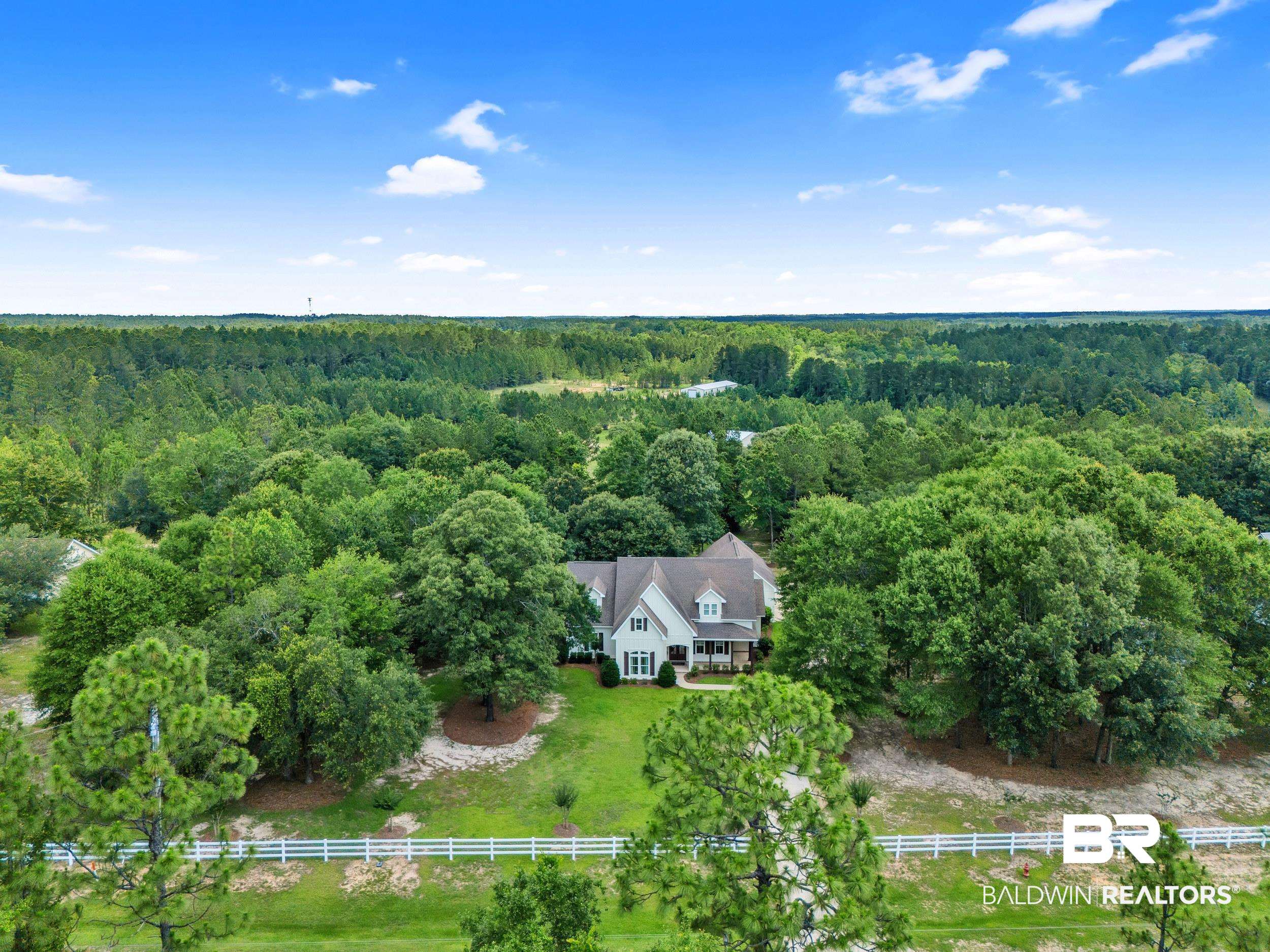 14531 Styx River Road Stapleton, AL 36578 - Photo 47 of 50 Aerial view of property and surrounding area with a heavily wooded area