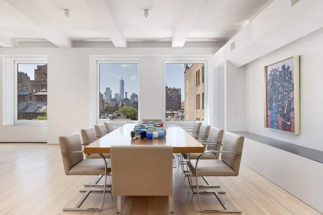 a dining room with furniture and wooden floor