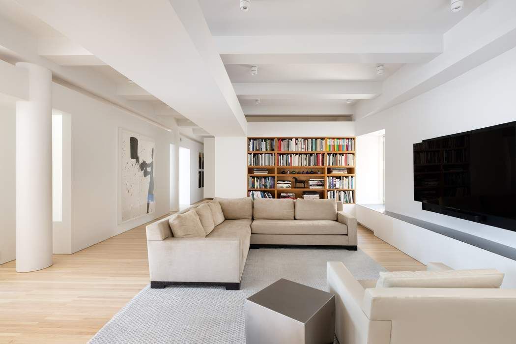 227 West 17th Street, Unit 7 Manhattan, NY 10011 - Photo 9 of 23 a living room with furniture and a flat screen tv