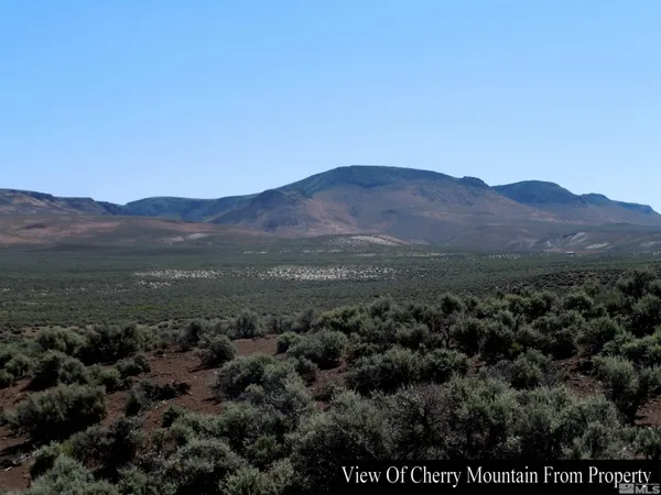 a view of a town with mountains in the background