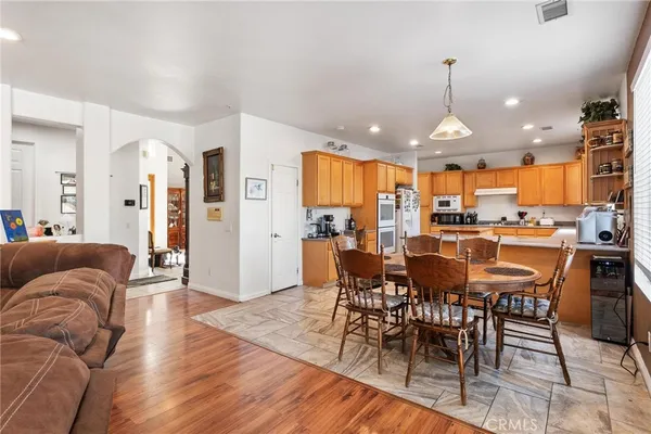a kitchen with stainless steel appliances granite countertop a sink counter space cabinets and a large window