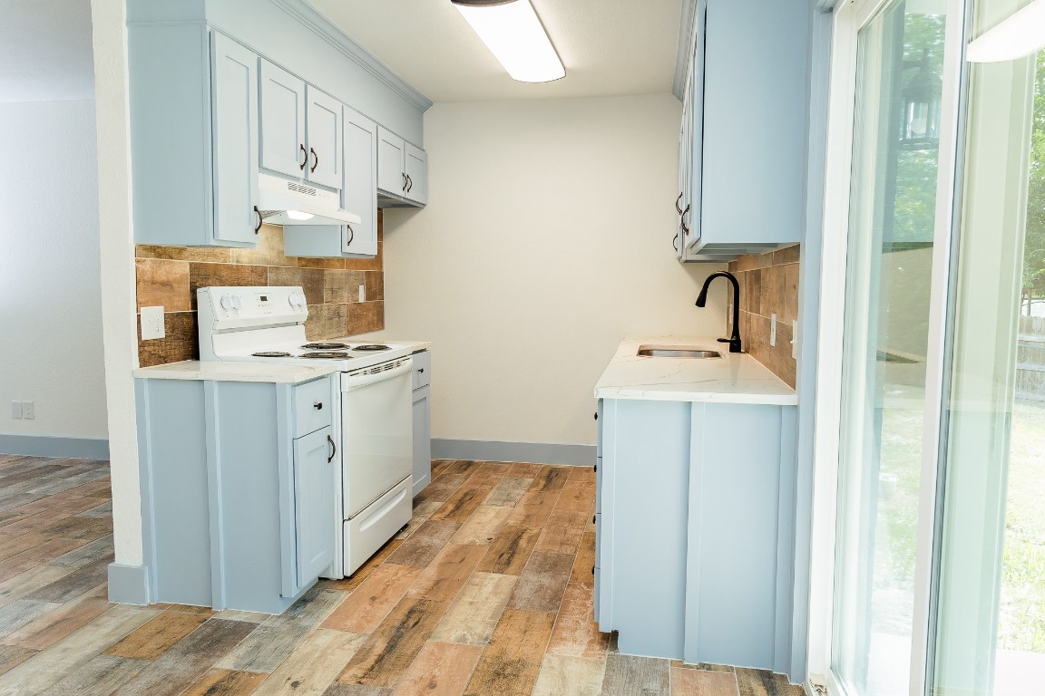 811 Matchett Street Brenham, TX 77833 - Photo 14 of 18 a kitchen with stainless steel appliances a sink stove and cabinets