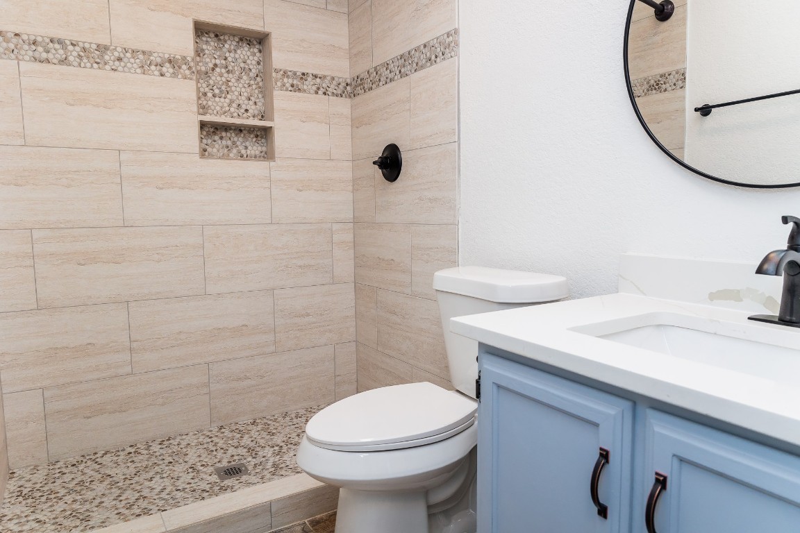 811 Matchett Street Brenham, TX 77833 - Photo 16 of 18 a bathroom with a sink a toilet and shower