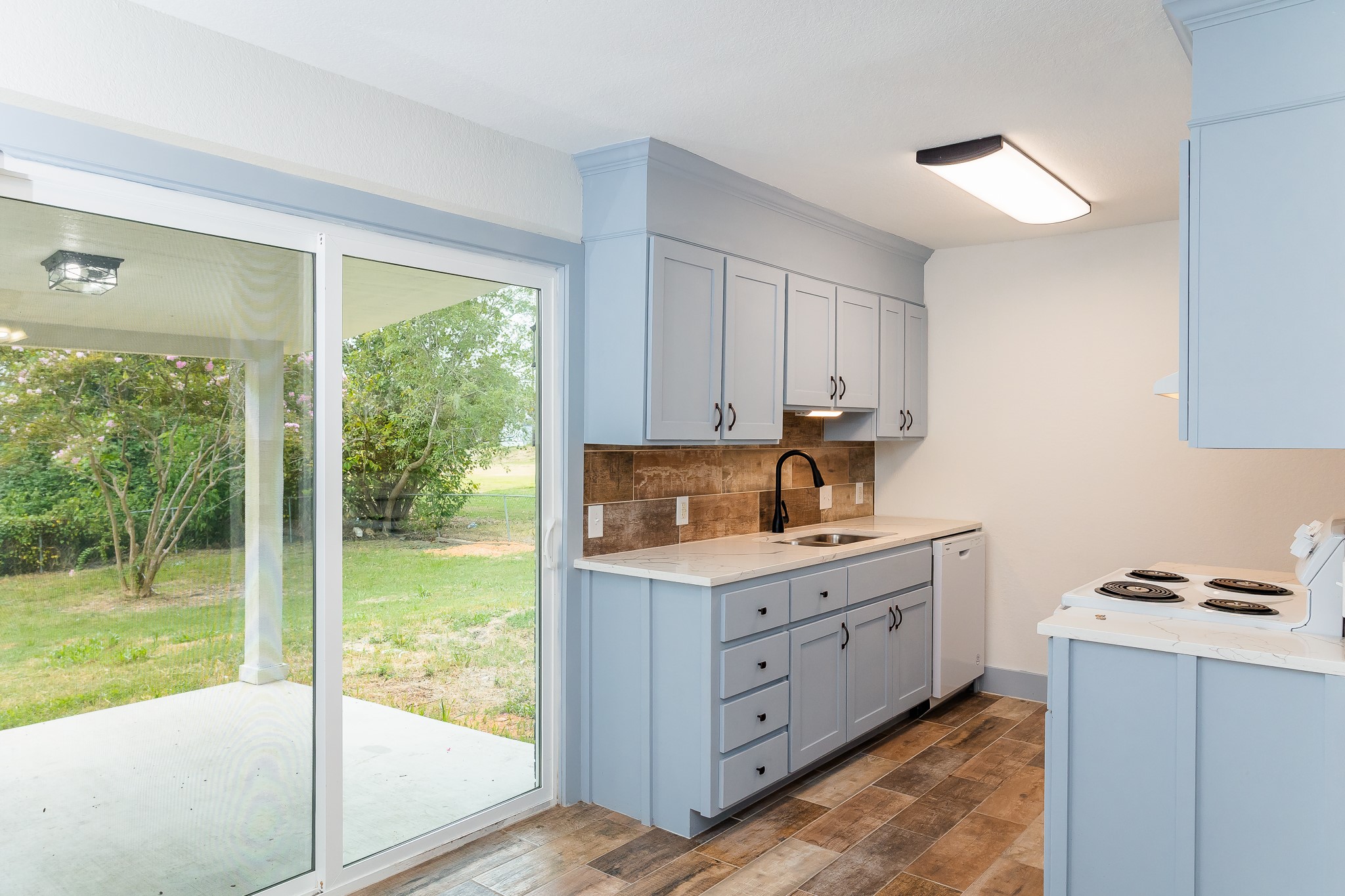 811 Matchett Street Brenham, TX 77833 - Photo 3 of 18 a kitchen that has a cabinets and a stove top oven