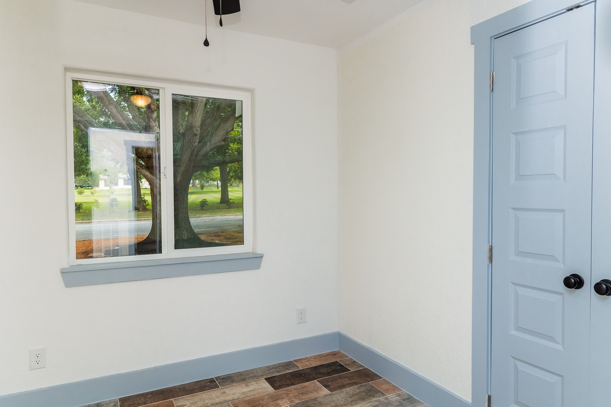 811 Matchett Street Brenham, TX 77833 - Photo 10 of 18 a view of empty room with window and wooden floor