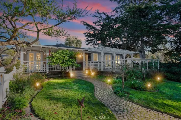 a front view of a house with yard and green space