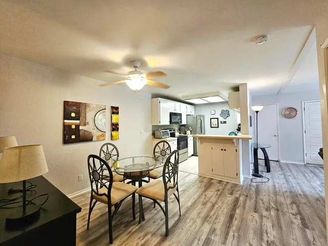 a view of a dining room with furniture and wooden floor