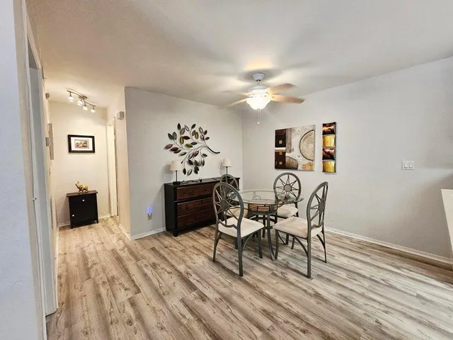 a view of a dining room with furniture and wooden floor