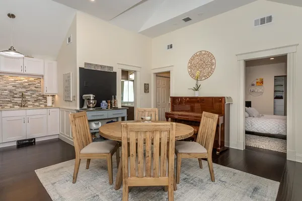 a view of a dining room with furniture and wooden floor