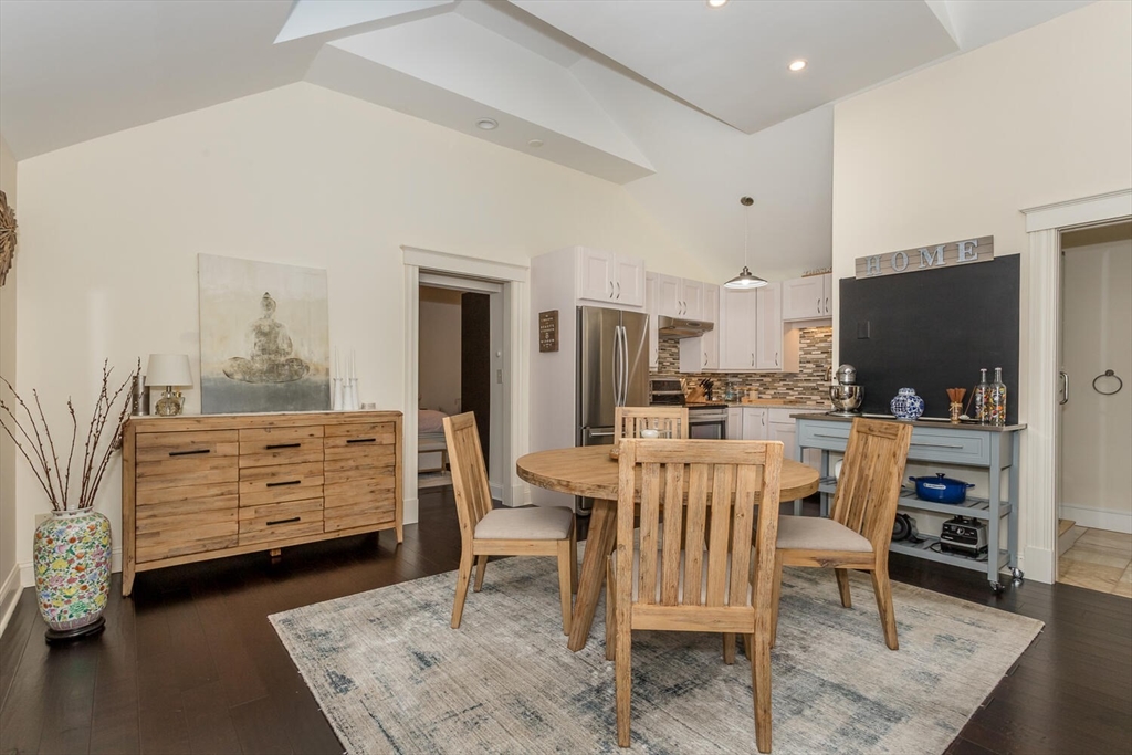 32 Billings Street, Unit 32R Sharon, MA 02067 - Photo 9 of 17 a kitchen with stainless steel appliances kitchen island granite countertop a table chairs and a refrigerator
