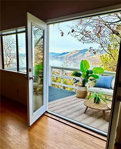 a view of a dining room with a floor to ceiling window and wooden floor