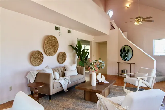 a living room with furniture and a large mirror