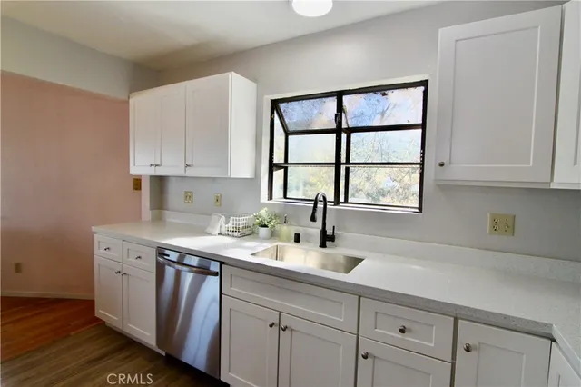 a kitchen with a sink cabinets and window