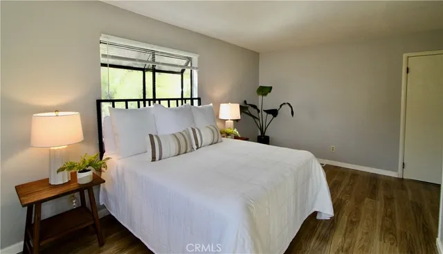 a bedroom with a bed and window