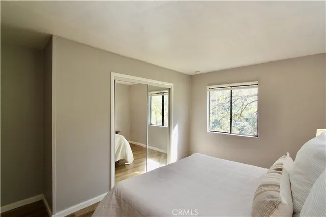 a bedroom with bed and a large mirror