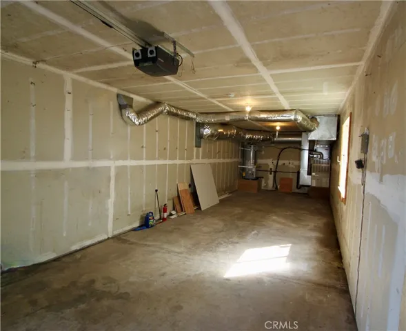 a view of a chairs and table on the wooden roof deck