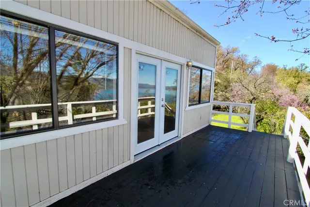 a view of a balcony with wooden floor and iron fence