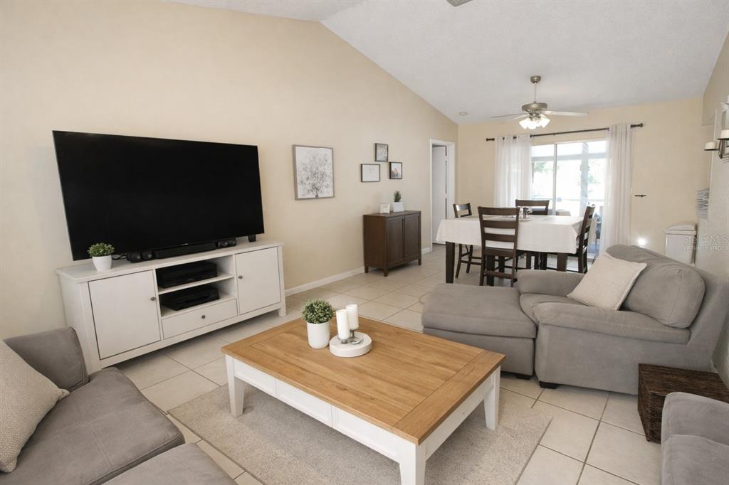 5046 Kenmore Street Spring Hill, FL 34608 - Photo 9 of 19 a living room with furniture and a flat screen tv