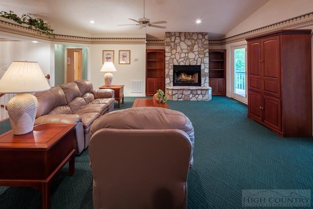 605 Pine Ridge Road Beech Mountain, NC 28604 - Photo 4 of 45 a living room with furniture a flat screen tv and a fireplace