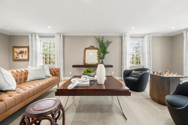 a spacious bedroom with a bed a dresser and a couch