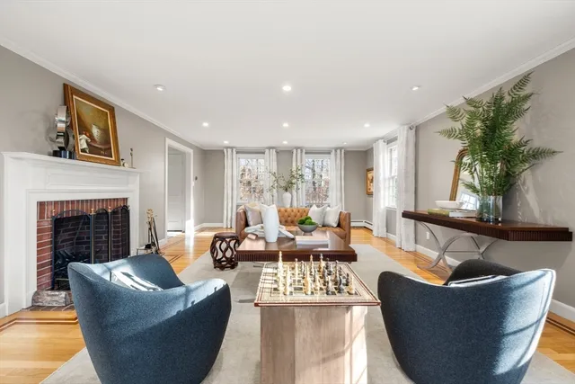 a bedroom with a bed a table and to ceiling window