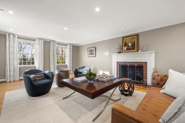 a living room with furniture and a glass table