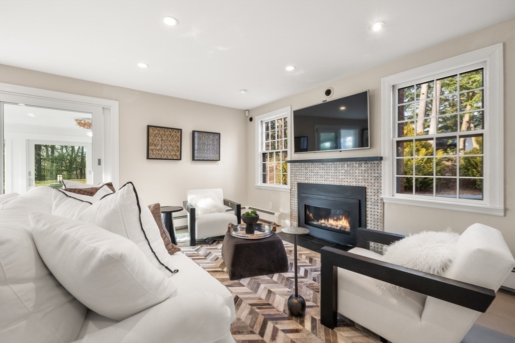 84 Royalston Road Wellesley, MA 02481 - Photo 20 of 42 a living room with furniture and a fireplace