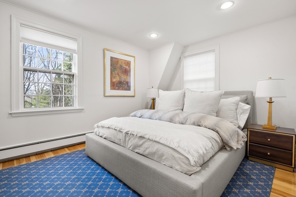 84 Royalston Road Wellesley, MA 02481 - Photo 34 of 42 a large bed sitting in a bedroom next to a window