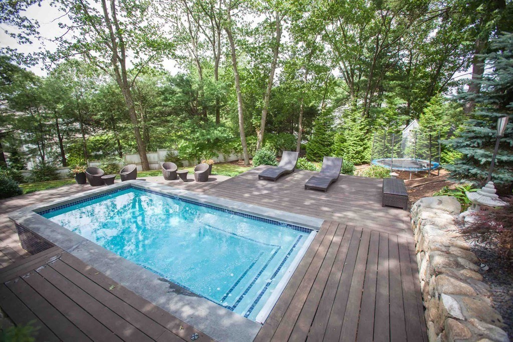 84 Royalston Road Wellesley, MA 02481 - Photo 8 of 42 a view of a wooden deck with chairs and large trees