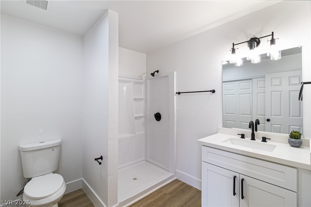 1891 Brian Road Pahrump, NV 89048 - Photo 37 of 50 Full bath with wood finished floors, visible vents, and a stall shower