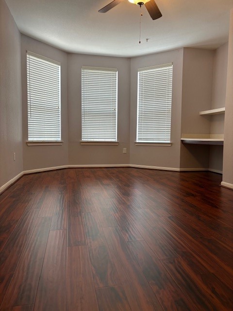 7575 Kirby Drive, Unit 3306 Houston, TX 77030 - Photo 2 of 18 an empty room with wooden floor and windows