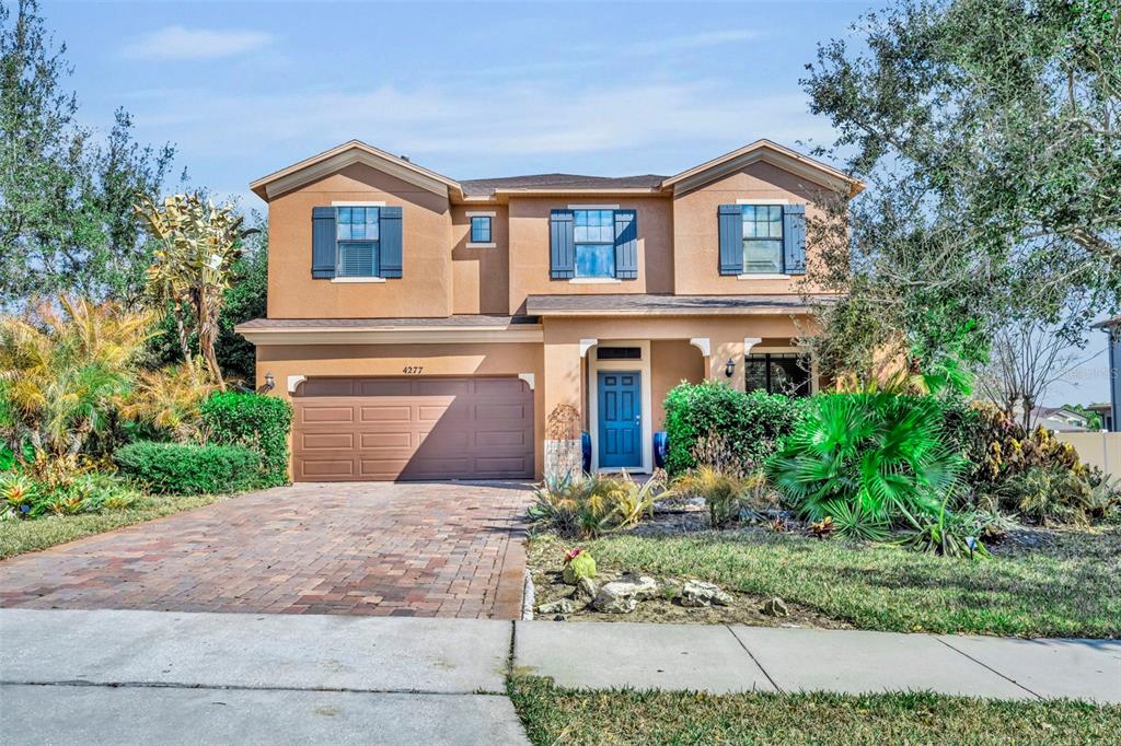 4277 Bugle Street Clermont, FL 34711 - Photo 1 of 35 a front view of a house with a garden