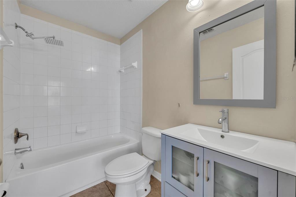 4277 Bugle Street Clermont, FL 34711 - Photo 32 of 35 a bathroom with a sink a toilet and shower