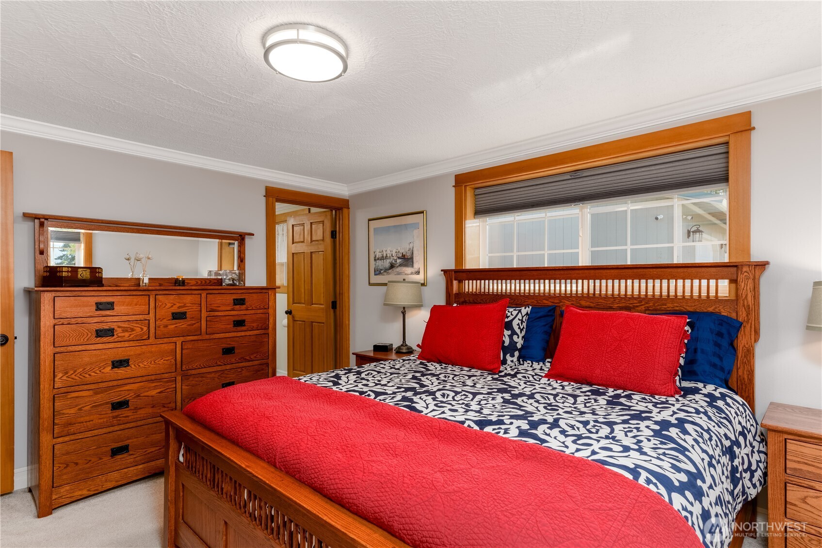 273702 Highway 101 Sequim, WA 98382 - Photo 15 of 40 a bedroom with a bed and a dresser