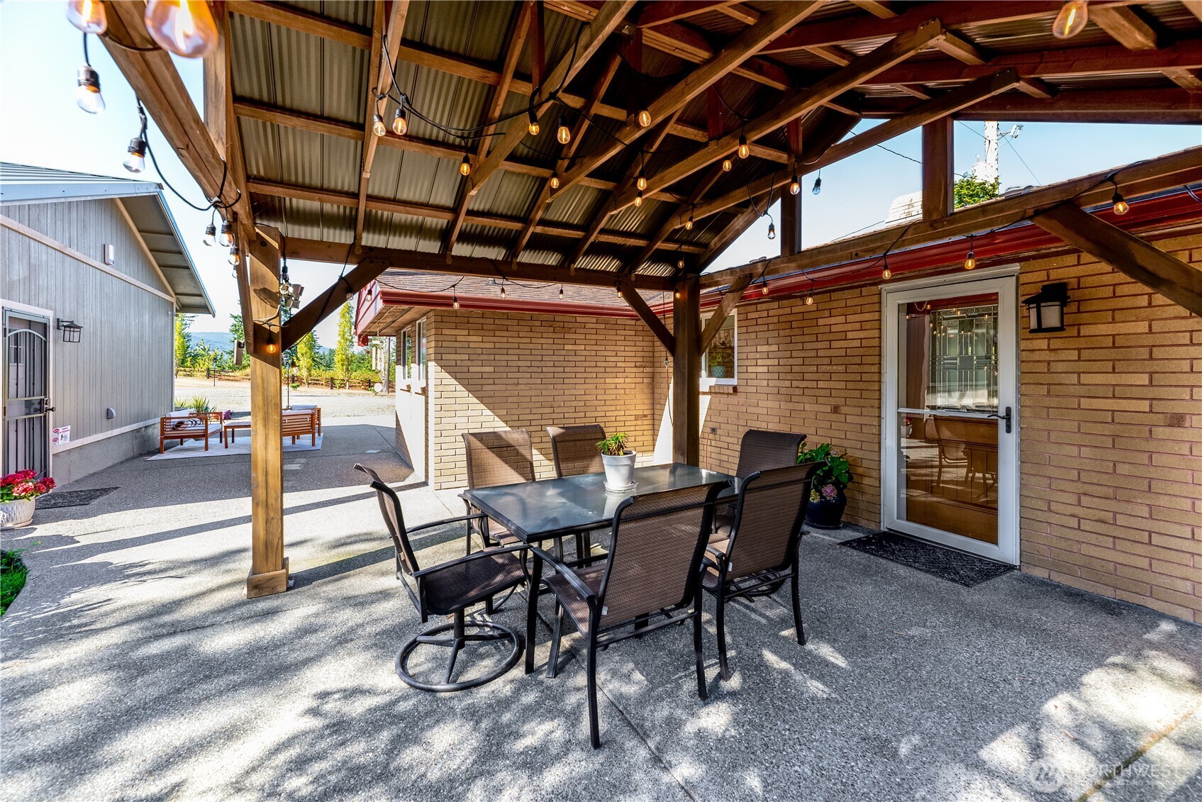 273702 Highway 101 Sequim, WA 98382 - Photo 20 of 40 a view of a patio with table and chairs and wooden floor
