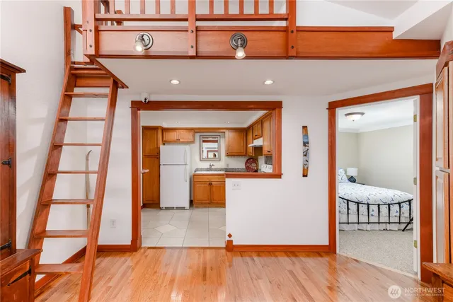 a bedroom with a bed and wooden floor