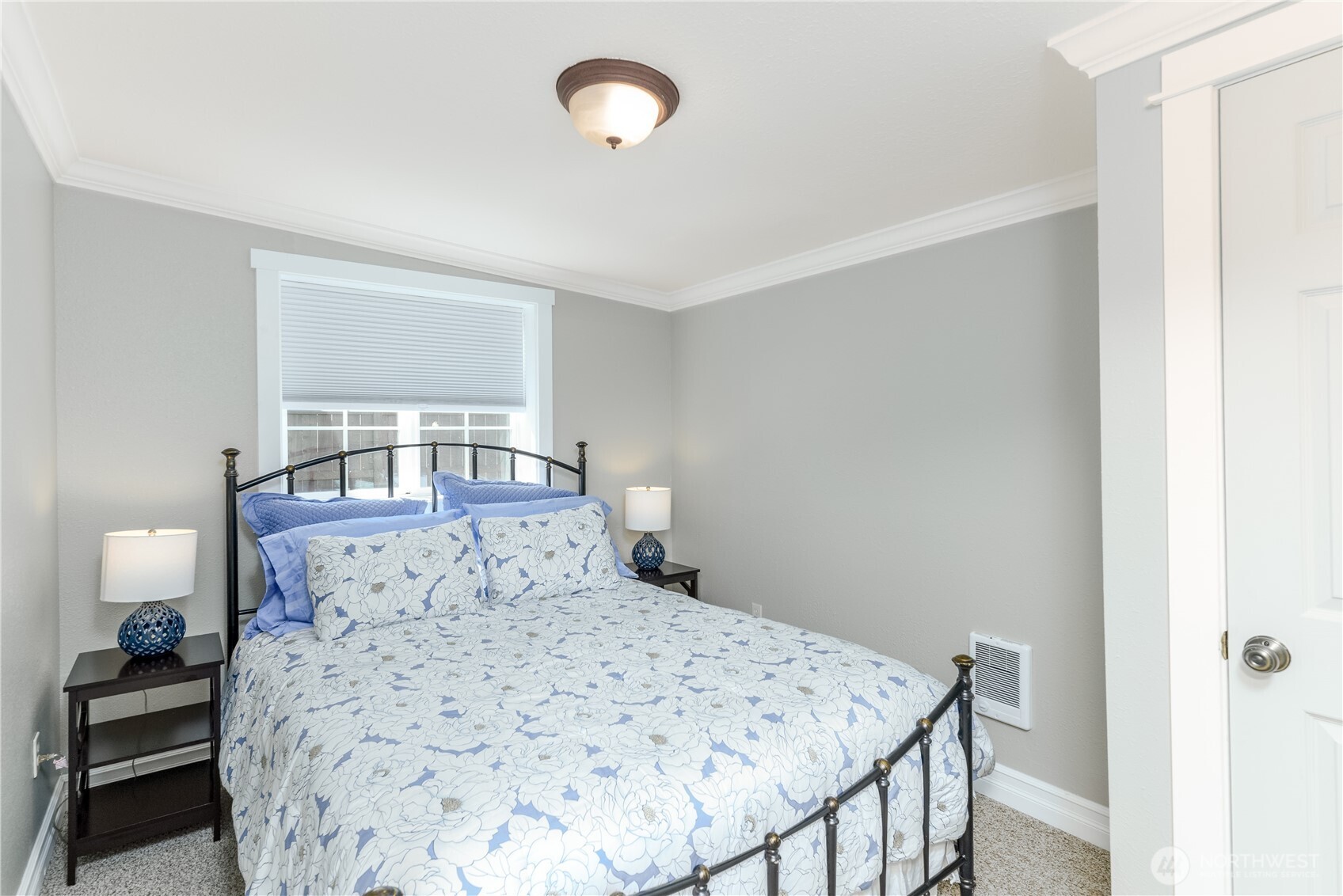 273702 Highway 101 Sequim, WA 98382 - Photo 29 of 40 a bedroom with a bed and wooden floor