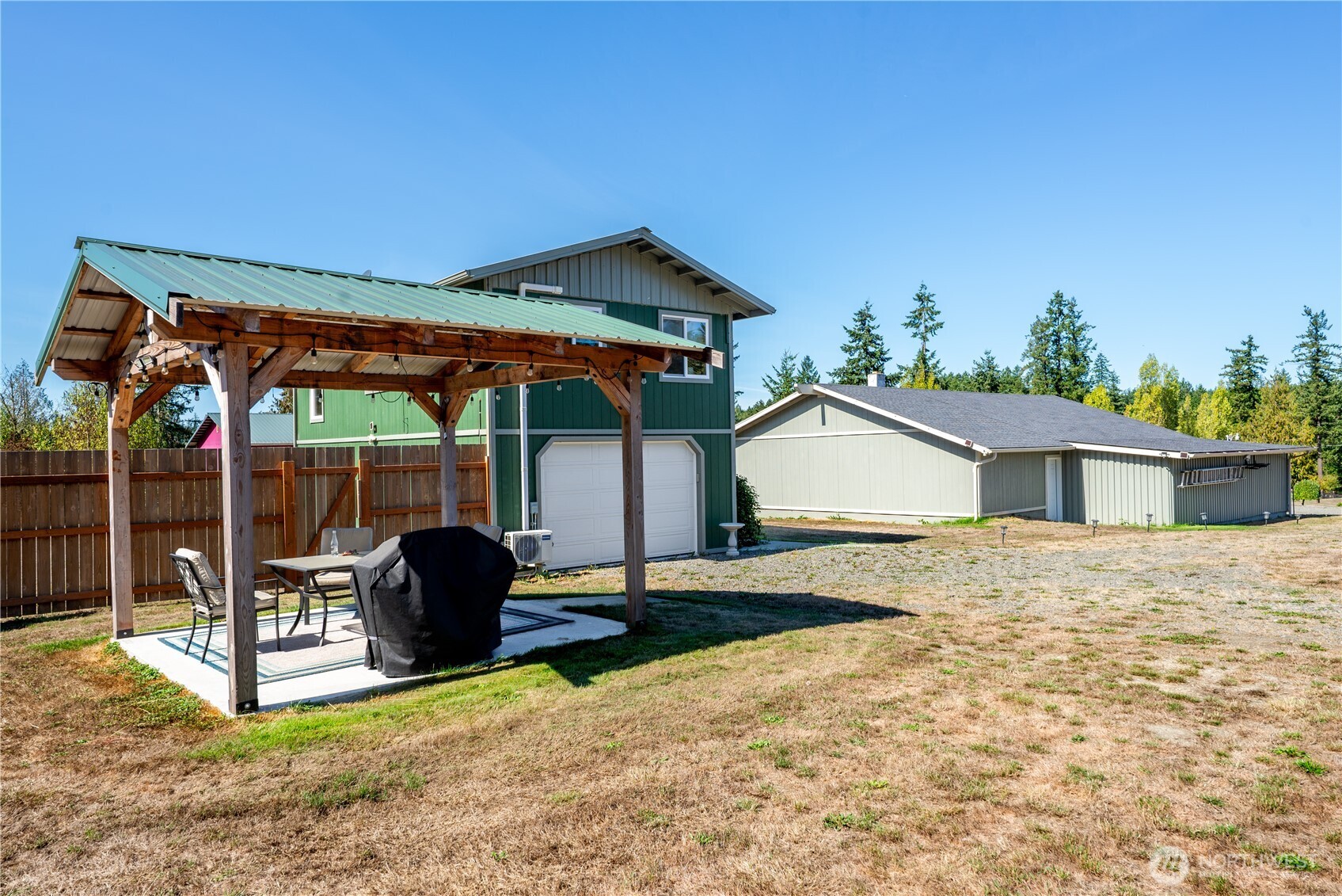 273702 Highway 101 Sequim, WA 98382 - Photo 30 of 40 a backyard of a house with table and chairs