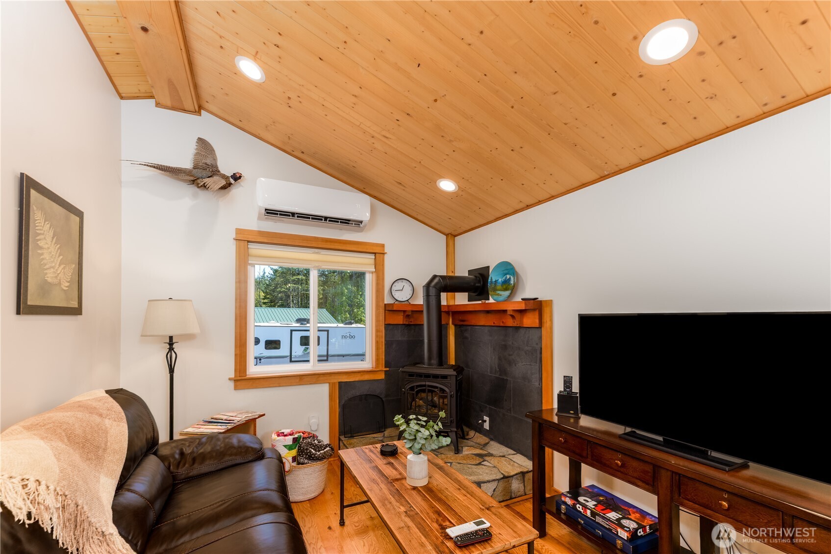 273702 Highway 101 Sequim, WA 98382 - Photo 35 of 40 a living room with furniture and a flat screen tv