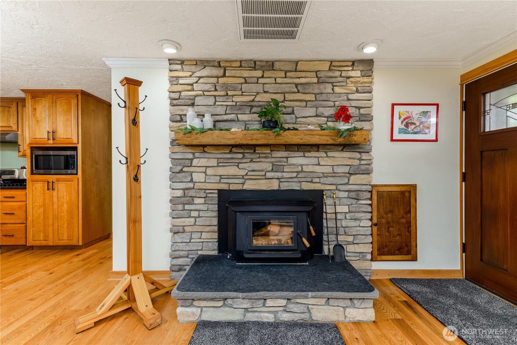 273702 Highway 101 Sequim, WA 98382 - Photo 7 of 40 a living room with a fireplace and a wooden floor