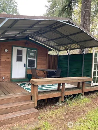 a view of backyard with deck and outdoor seating