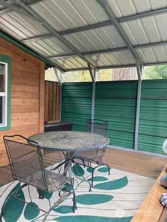a view of backyard with wooden fence
