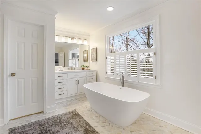 a view of a kitchen with white cabinets and wooden floor