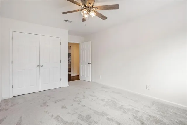 a view of a porch with wooden floor and a floor to ceiling window and wooden fence