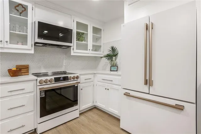 a bedroom with a bed wooden floor and window