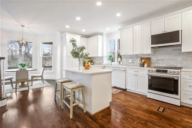 a view of a dining room with furniture wooden floor and a chandelier