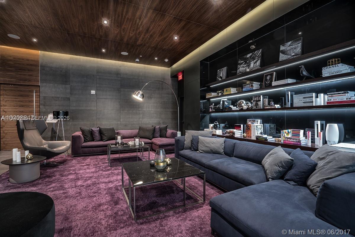 68 Southeast 6th Street, Unit 3402 Miami, FL 33131 - Photo 19 of 22 a living room with furniture and a book shelf