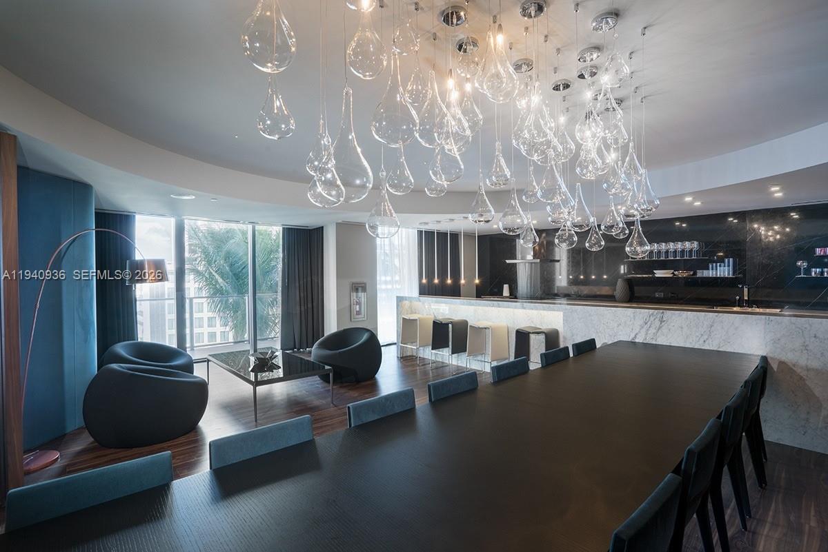 68 Southeast 6th Street, Unit 3402 Miami, FL 33131 - Photo 21 of 22 a living room with furniture and a flat screen tv