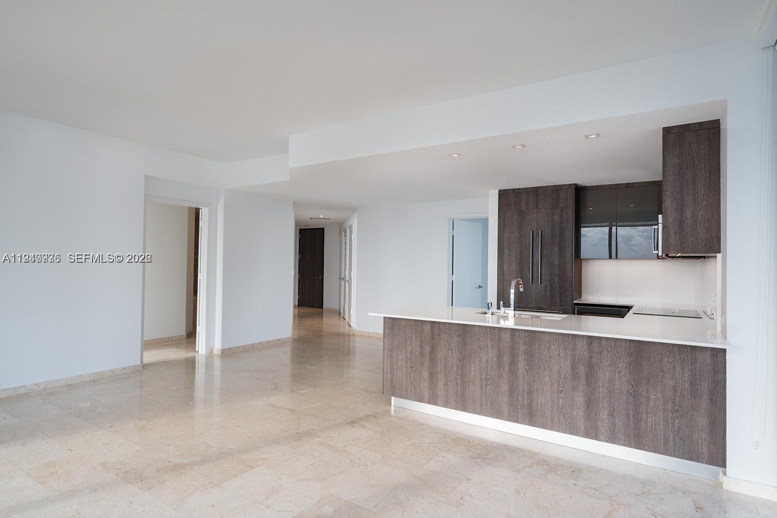 68 Southeast 6th Street, Unit 3402 Miami, FL 33131 - Photo 3 of 22 a view of a kitchen with a sink and an entryway