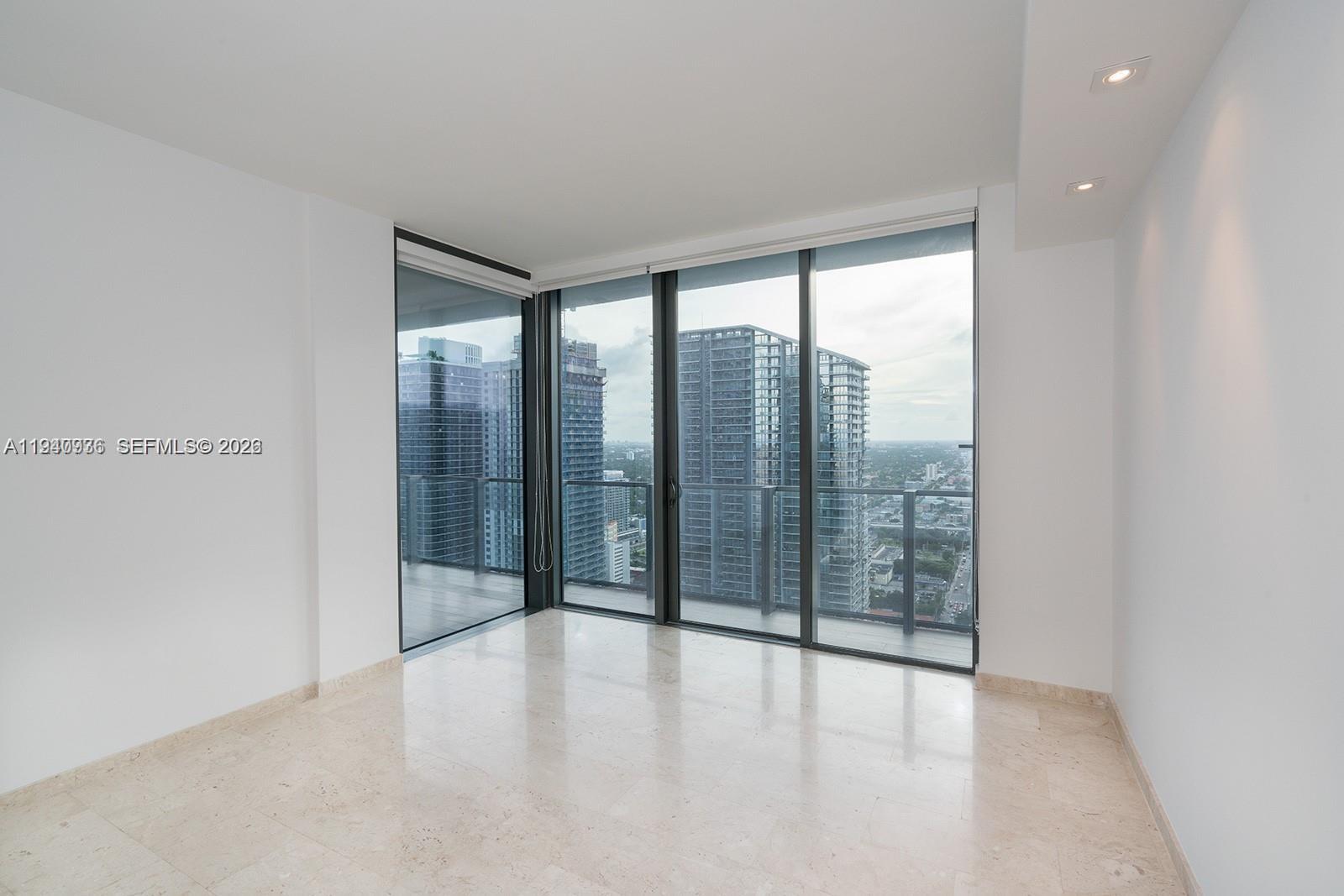 68 Southeast 6th Street, Unit 3402 Miami, FL 33131 - Photo 6 of 22 a view of an empty room with windows